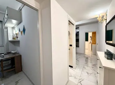 a bathroom with white walls and a large mirror at CHANGE S house, Few stops from St Peter s in Rome