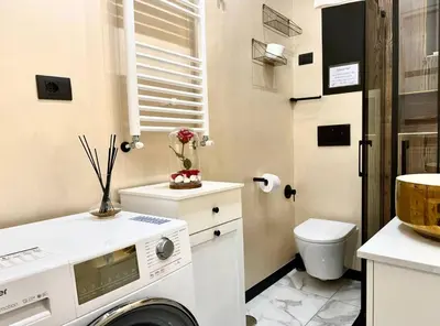 a small bathroom with a washing machine in it at CHANGE S house, Few stops from St Peter s in Rome