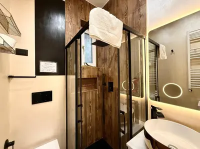a bathroom with a glass shower and a sink at CHANGE S house, Few stops from St Peter s in Rome