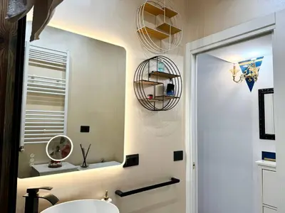 a bathroom with a white sink and a mirror at CHANGE S house, Few stops from St Peter s in Rome