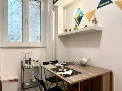 a dining room with a wooden table and chairs at CHANGE S house, Few stops from St Peter s in Rome