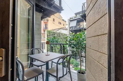 a patio with a table and chairs on a balcony at Domus Urbana 152 in Rome