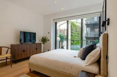 a bedroom with a bed and a large window at Domus Urbana 152 in Rome