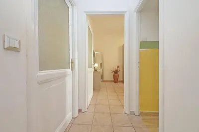 a hallway with a white door and a tile floor at Typical roman home in Testaccio in Rome