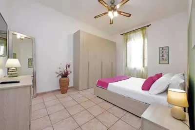 a bedroom with a large bed and a bathroom at Typical roman home in Testaccio in Rome