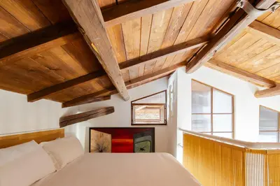 a bedroom with wooden ceilings and a large bed at Villa Agostina in Rome