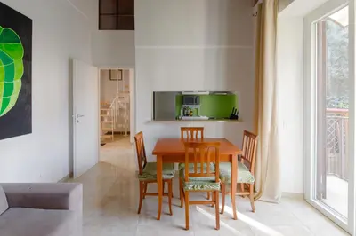 a dining room with a wooden table and chairs at Villa Agostina in Rome