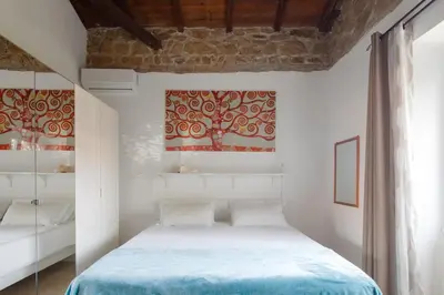 a bedroom with a bed with a blue blanket at Villa Agostina in Rome