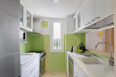 a kitchen with green tiles on the walls and a sink at Villa Agostina in Rome