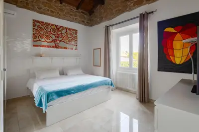 a white bedroom with a bed and a window at Villa Agostina in Rome