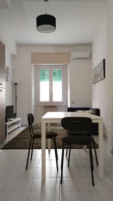 a dining room with a white table and two chairs at Roma Metro Camillo Porzio in Rome