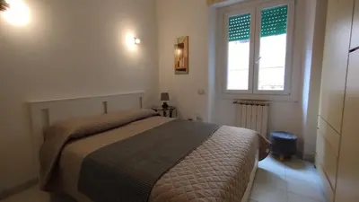 a bedroom with a bed and a window at Roma Metro Camillo Porzio in Rome