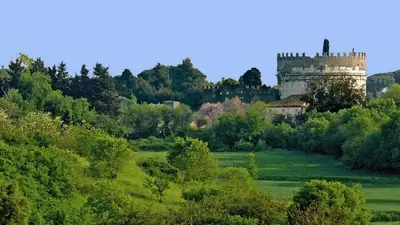 a castle in the middle of a field with trees at Roma Metro Camillo Porzio in Rome