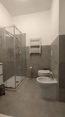 a bathroom with a toilet and a glass shower at Roma Metro Camillo Porzio in Rome