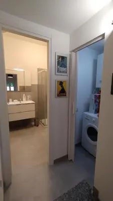 a bathroom with a sink and a washing machine at Roma Metro Camillo Porzio in Rome
