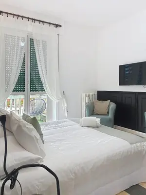 a bedroom with a large white bed and a window at Villa Carpegna House 10 Minuti from Vatican San Peter in Rome