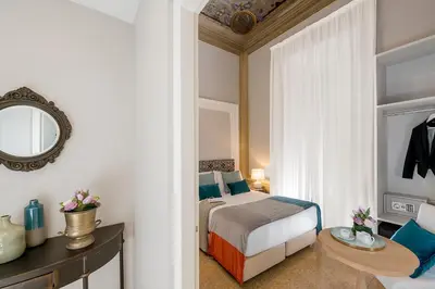 a bedroom with a bed and a table and a mirror at Boutique Hotel Atelier '800 in Rome