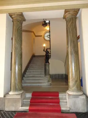 a staircase with columns and a red carpet at Boutique Hotel Atelier '800 in Rome