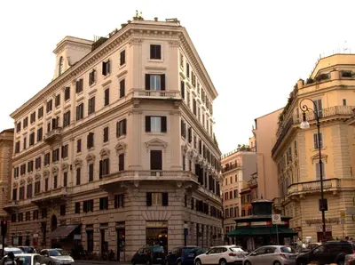 a tall building on a city street with parked cars at Boutique Hotel Atelier '800 in Rome