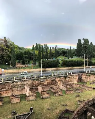 a car driving down a road next to a bridge at Royal Rooms in Rome