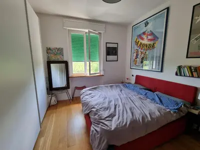 a bedroom with a bed and a television in it at Incantevole bilocale a Città Giardino in Rome