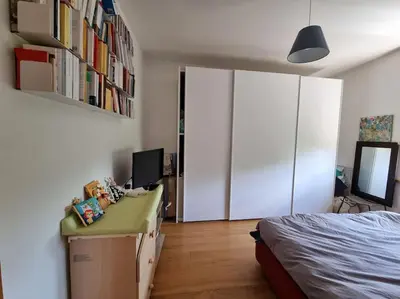 a bedroom with a bed and a desk with a computer at Incantevole bilocale a Città Giardino in Rome