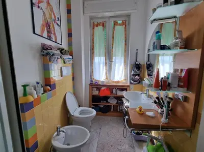 a bathroom with two sinks and a toilet at Incantevole bilocale a Città Giardino in Rome