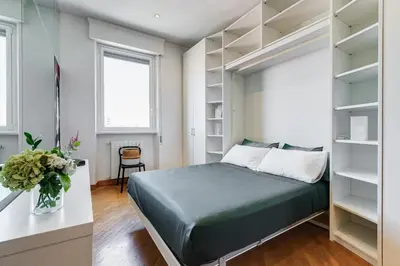a bedroom with a bed and shelves at Romaviva Luxury Attic Apartment - San Giovanni in Laterano - Metro A C - Central Rome in Rome