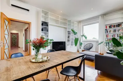 a living room with a wooden table and chairs at Romaviva Luxury Attic Apartment - San Giovanni in Laterano - Metro A C - Central Rome in Rome
