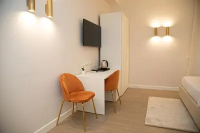 a small room with a desk and a bed at Roxy luxury house Rome in Rome