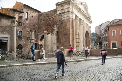 a group of people walking around an old building at Roxy luxury house Rome in Rome
