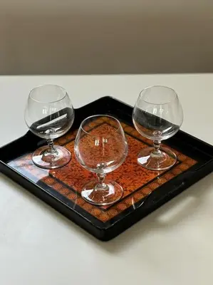 three wine glasses on a tray on a table at Vatican Green Penthouse in Rome