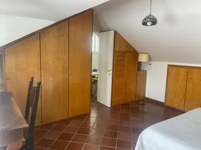 a room with wooden cabinets and a bed in it at Vatican Green Penthouse in Rome