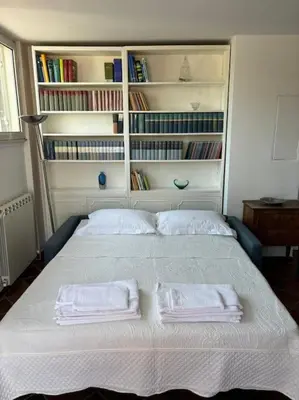 a bedroom with a bed with two towels on it at Vatican Green Penthouse in Rome