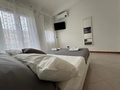 a bedroom with a bed with two towels on it at Vacanze Romane Apartment in Rome in Rome