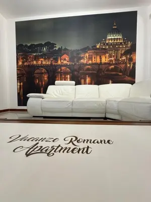 a white couch in front of a picture of a city at Vacanze Romane Apartment in Rome in Rome