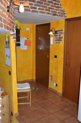 a bedroom with a bed with orange walls at La Casetta Gialla di Edoardo in Rome