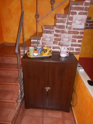 a living room with an orange chair and a desk at La Casetta Gialla di Edoardo in Rome