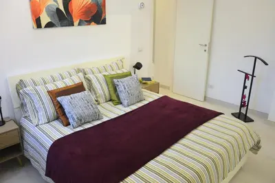 a bedroom with a bed and a couch with pillows at Arese Undici in Rome