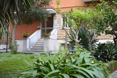 a house with stairs and plants in front of it at Arese Undici in Rome