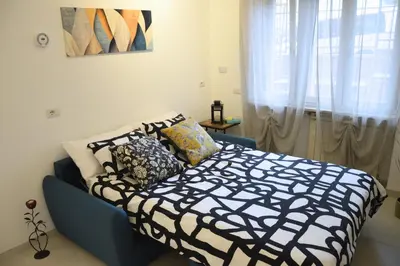 a bedroom with a bed with a black and white comforter at Arese Undici in Rome