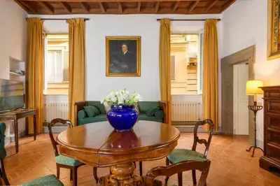 a living room with a vase of flowers on a table at Cartari Deluxe Apartment in Rome