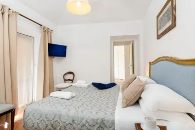 a hotel room with a bed and a window at Cartari Deluxe Apartment in Rome