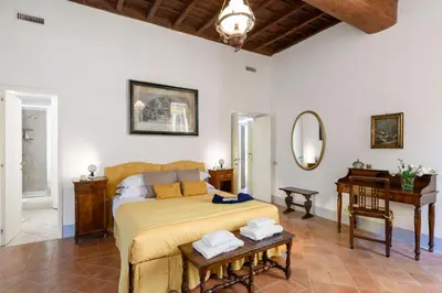 a bedroom with a bed and a table and a mirror at Cartari Deluxe Apartment in Rome