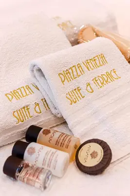a group of spa towels and a bottle of sunscreen at Piazza Venezia Suite and Terrace in Rome