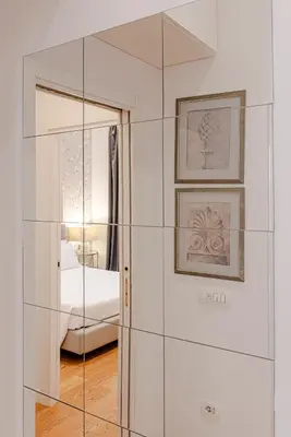 a glass partition in a room with a bedroom at Piazza Venezia Suite and Terrace in Rome