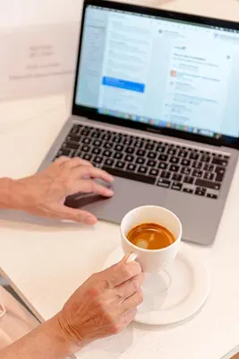 a person sitting at a table with a cup of coffee at Piazza Venezia Suite and Terrace in Rome