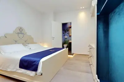 a bathroom with a shower with flowers on the wall at Vatican Family Romantic Suite in Rome