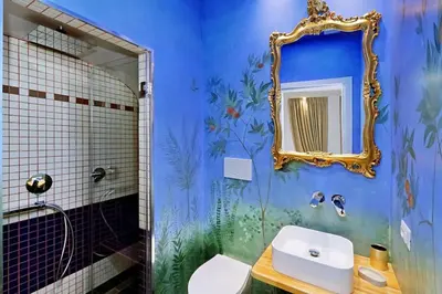 a kitchen with a table and a purple and white wall at Vatican Family Romantic Suite in Rome