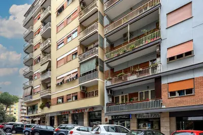 an apartment building with cars parked in front of it at Veroli Vacanze Romane in Rome
